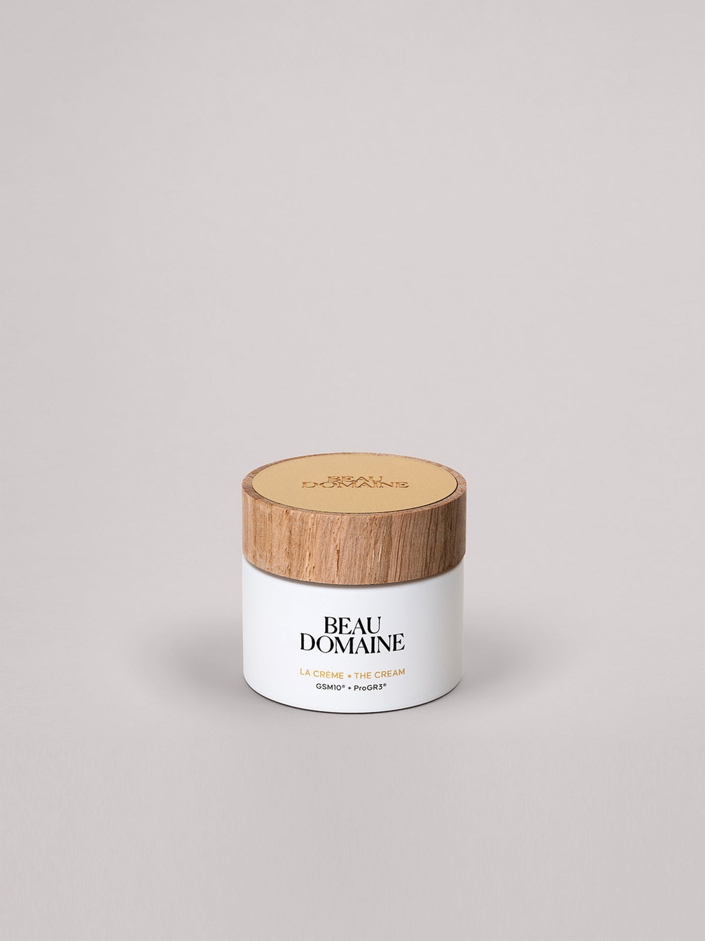 White jar with wooden lid labeled 'Beau Domaine' on a light gray background