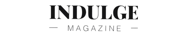 Logo of Indulge Magazine in black text with decorative elements.